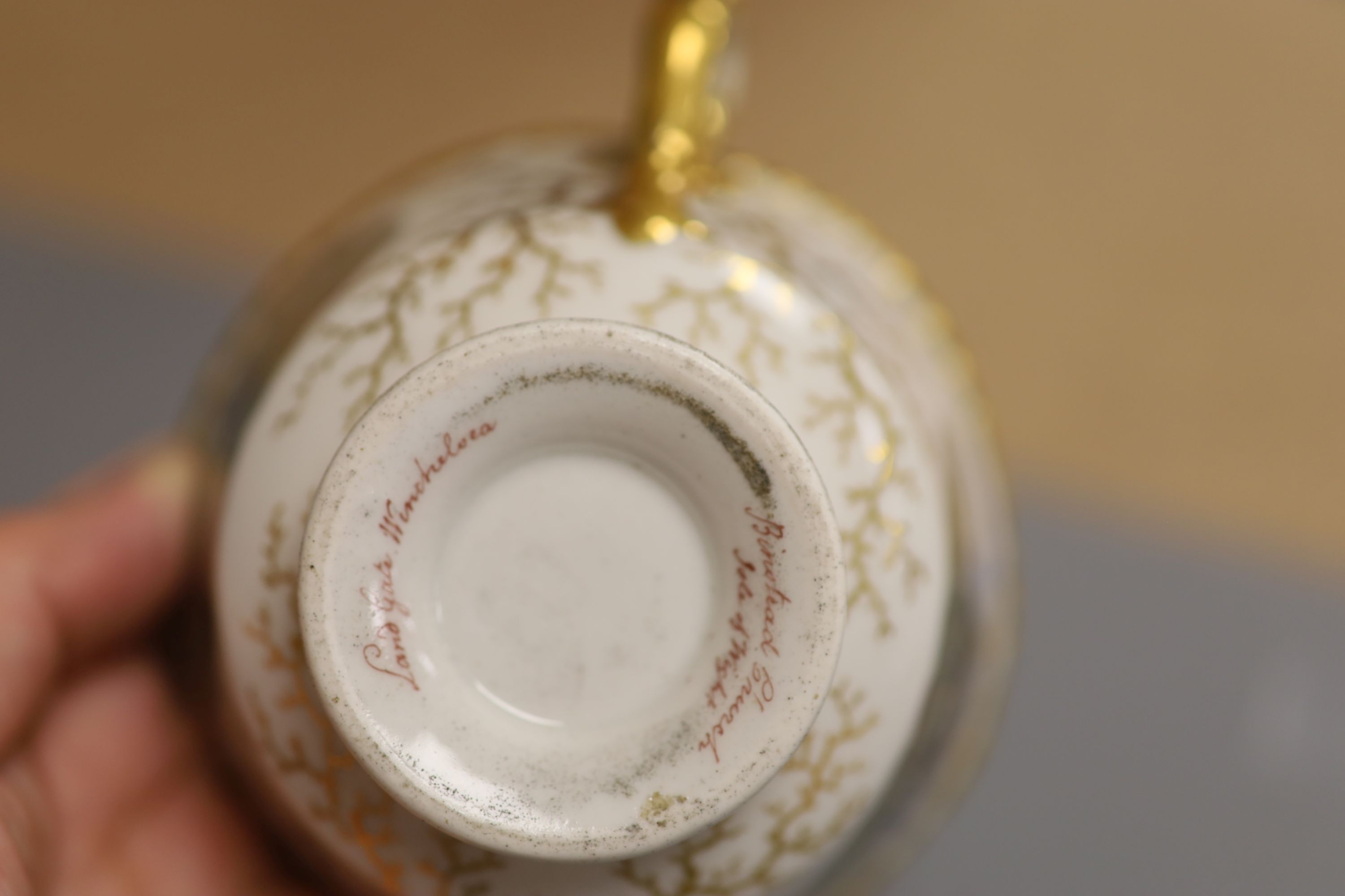 A Flight Barr & Barr cup and saucer, painted with Binstead cottage, Isle of White and Land Gate, Winchelsea, the saucer with country folk diameter 15cm